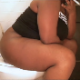 A big, black woman smokes a cigarette while she takes a piss and a shit sitting on a toilet. Plops are heard. She stands up to wipe her ass. Audio is slightly compressed. Over 4.5 minutes.